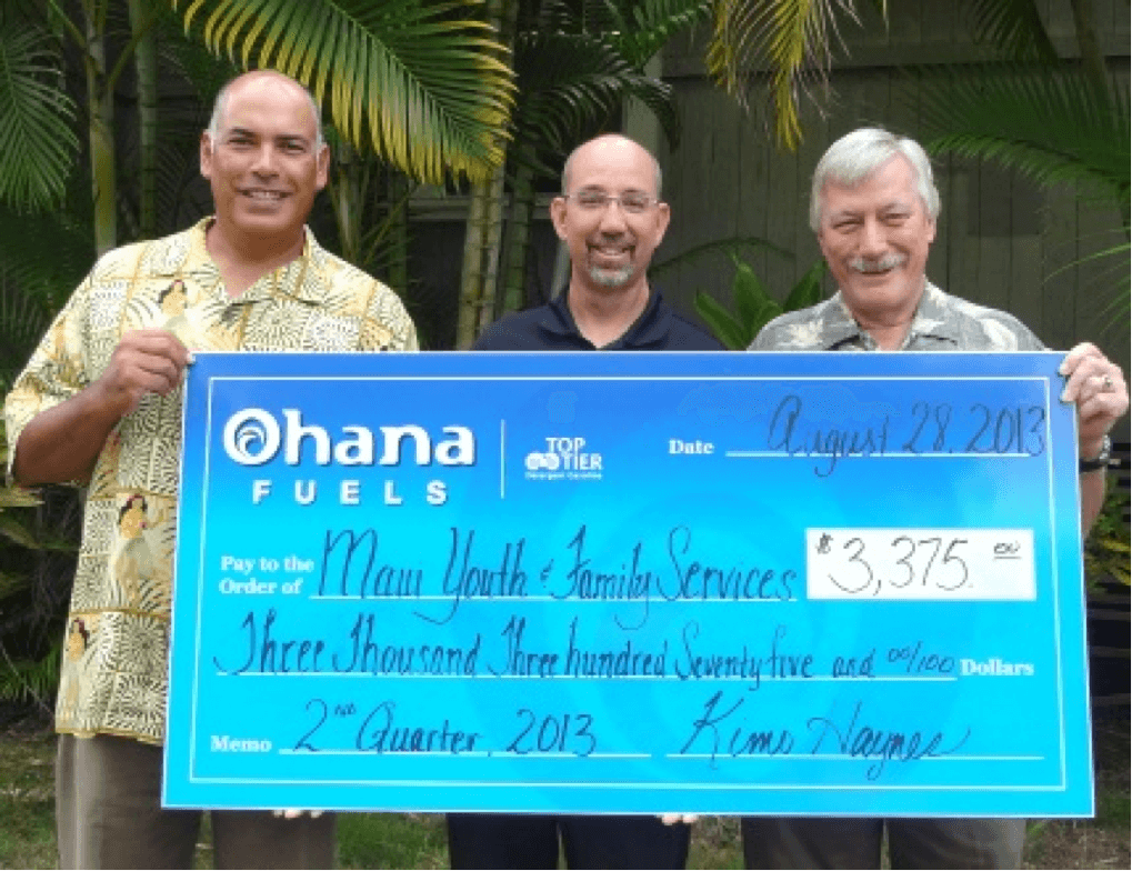 Maui Petroleum President Kimo Haynes (left) and General Manager Steve Wetter (center) present a check to MYFS Chief Executive Officer Judd Cunningham (right) 